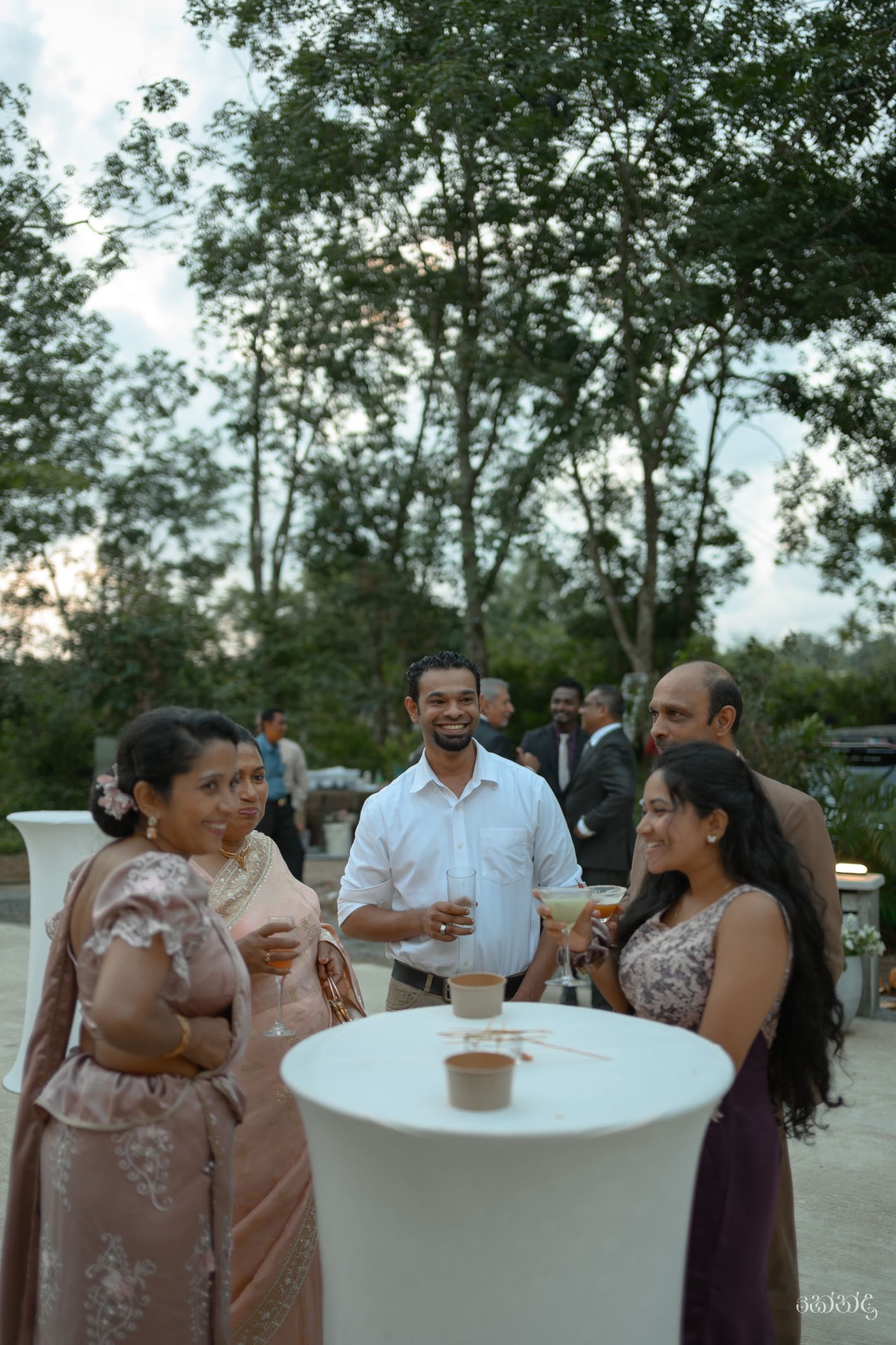 Welcome drinks served to wedding guests arriving on the estate lawn
